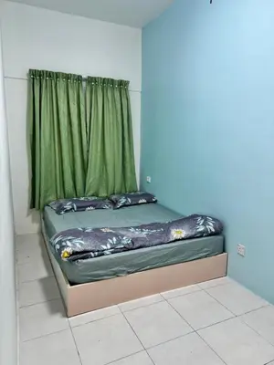 a bed in a room with a green curtain at AYAAN LAVISH HOMESTAY with FREE WiFi in Tanah Rata