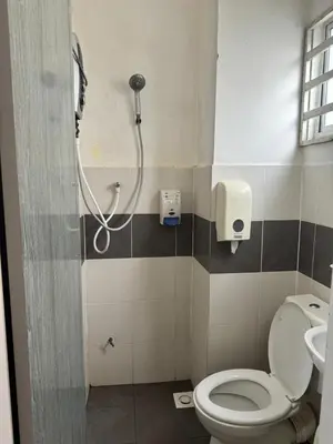 a bathroom with a shower with a toilet and a sink at AYAAN SERENE BUDGET HOMESTAY with FREE WiFi and Netflix in Tanah Rata