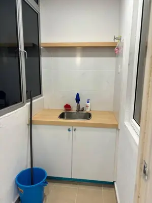 a small kitchen with a sink and a bucket at KF Homestay Double Suite in Kampar