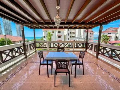 a patio with a table and chairs on a balcony at PRIME Location - 5 Mins Walk to Shops & Eateries! in Tanjung Bungah