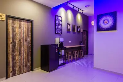 a bar in a restaurant with purple lighting at Heaven 5BR Garden Inn by uBook in Butterworth