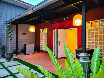 a porch of a house with a yellow and red at Great 5BR Garden Inn by uBook in Butterworth