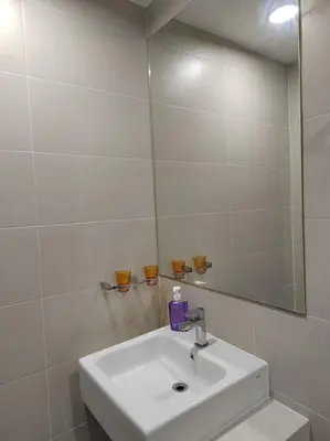 a white bathroom with a sink and a mirror at Purrfect Nook 1BR Georgetown Straits Garden \u4e00\u623f\u4e00\u5385\u5f0f in Jelutong
