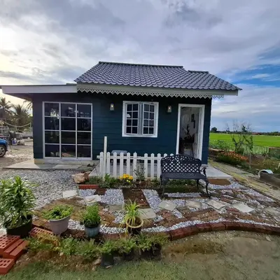 a blue house with a bench in front of it at Husna homestay in Sungai Besar