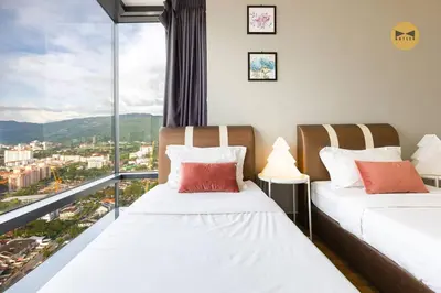 two beds in a room with a view of a city at Spacious 3BR in Tropicana 218 at Central Location & Food Hunt Friendly in George Town