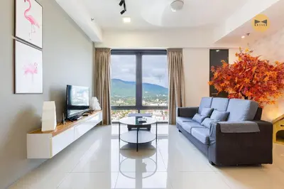 a living room with a blue couch and a television at Spacious 3BR in Tropicana 218 at Central Location & Food Hunt Friendly in George Town