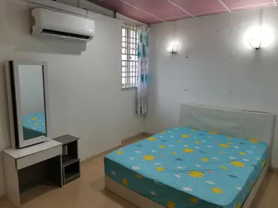a bedroom with a bed and a tv in it at Amoy Lane Hostel Penang in George Town