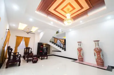 a living room with a coffered ceiling and a staircase at Bukit Mertajam Double Storey Bungalow 15pax BBQ KTV in Bukit Mertajam