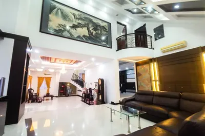 a living room with a couch and a table at Bukit Mertajam Double Storey Bungalow 15pax BBQ KTV in Bukit Mertajam