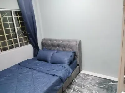 a couch in a room with two pillows on it at Amara Homestay Cameron Highlands in Cameron Highlands