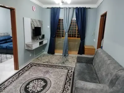 a living room with a couch and a television at Amara Homestay Cameron Highlands in Cameron Highlands