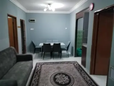 a living room with a couch and a table with chairs at Amara Homestay Cameron Highlands in Cameron Highlands