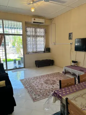a living room with a couch and a tv at Homestay Cikgu Siti teluk intan in Teluk Intan