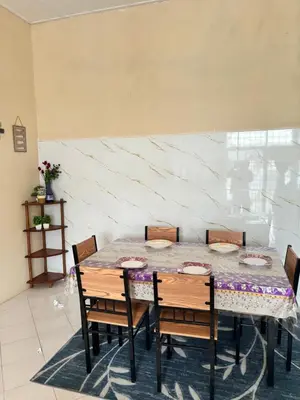 a dining room with a table and chairs at Homestay Cikgu Siti teluk intan in Teluk Intan