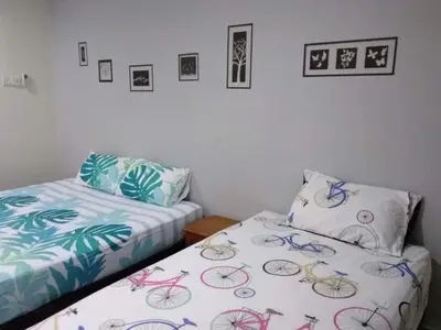 two beds sitting next to each other in a bedroom at Ipoh Budget in Ipoh
