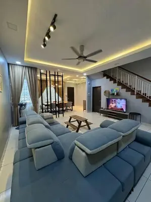 a living room with a large blue sectional couch at Stylaa Homestay Bertam in Kepala Batas