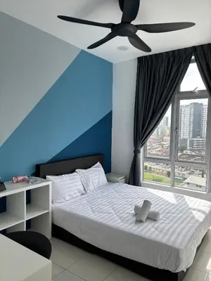a bedroom with a bed with a ceiling fan at Anderson Ipoh by Iconique Espace in Ipoh