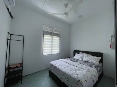a bedroom with a bed and a window and a mirror at Anggerik Homestay suasana kampung in Kampong Batu Dua Puloh Tiga
