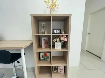 a book shelf with a desk and a clock on it at Ipoh Town Centre The Anderson For 5pax in Ipoh