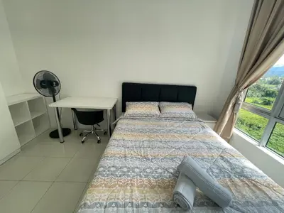 a bedroom with a bed with a desk and a window at Ipoh Town Centre The Anderson For 5pax in Ipoh