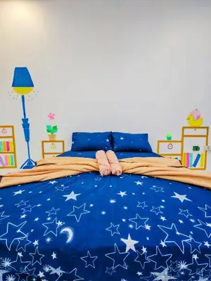 a bedroom with a blue bed with stars on it at GOLDEN HOUSE ,1min to aeon, 7min to zoo,8min to lake gardens in Taiping