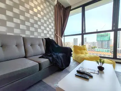 a living room with a couch and a table at SoftGrey 2 Rooms Apartment, 4 plus 2 Pax at Urban Suites in Jelutong