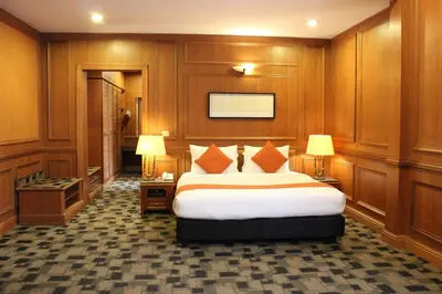 a hotel room with a bed and two lamps at Cinta Sayang Resort in Sungai Petani