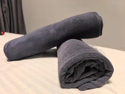 a rolled up towel on top of a bed at Ipoh Town 2224 six pax By Hopestay in Ipoh