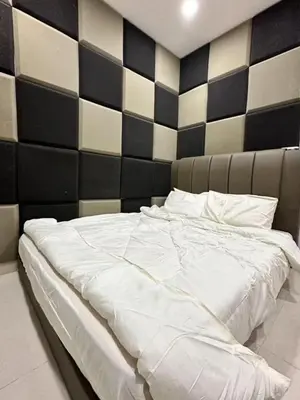 a large white bed in a bedroom with a black and white wall at \u5bb6\u5bb6\u6c11\u5bbf in Nibung Tebal