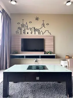 a living room with a tv and a table at SweeT Homestay in Perai