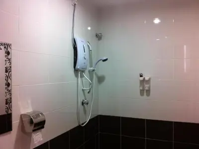 a shower in a bathroom with a phone on the wall at Chin Yee Hotel in Teluk Intan