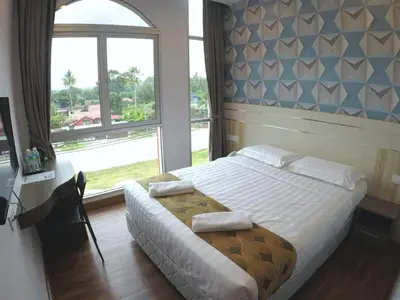 a bedroom with a bed and a large window at HOTEL KAWAN BIDOR in Bidur