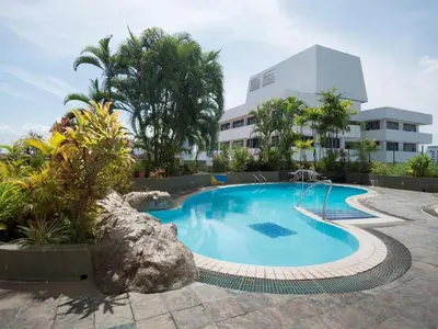 a swimming pool in front of a building at Hotel Royal Penang in George Town
