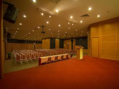 a conference room with chairs and a podium and a stage at Hotel Continental Penang in George Town