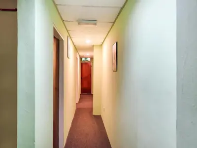a corridor of an office building with a hallway at OYO 89584 Hotel Sahara Kuala Kubu Bharu in Kuala Kubu Baharu