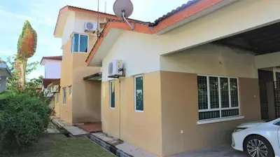 a house with a car parked in front of it at Hotel O D'hitech Home in Kampong Sungai Badak