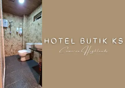 a hotel bathroom with a toilet and a shower at Hotel Butik KS in Brinchang