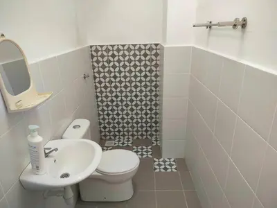a bathroom with a white toilet and a sink at IFS SoHo Basic Homestay Entire Home in Seri Iskandar