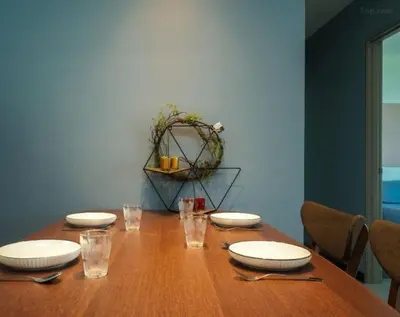 a wooden table with plates and glasses on it at 3 Bedroom Izz Homestay Casa kayangan in Ipoh