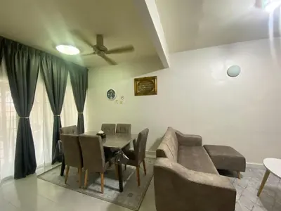 a dining room with a couch and a table at Imtiyaz Islamic Homestay in Kulim