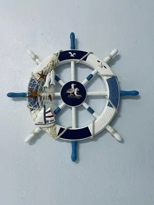 a blue and white clock on a wall at D Ocean Homestay in Seri Manjung