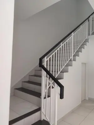 a staircase with black and white railings in a white room at Raub Newly French Style Homestay\u52b3\u52ff\u5168\u65b0\u6c11\u5bbf-\u9760\u8fd1\u69b4\u83b2\u56ed in Raub