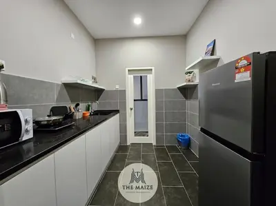 a kitchen with a refrigerator and a counter top at The Cove Hillside Residence Ipoh - Downtown Delight in Ipoh