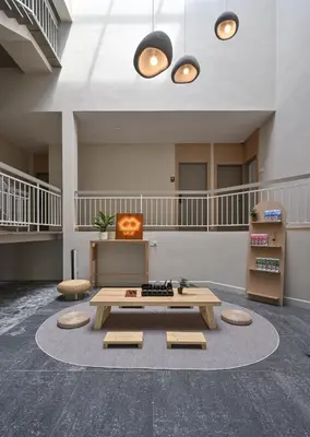 a large lobby with a table and chairs in a building at Simple Sanctuary Tanjung Tokong in Tanjung Bungah