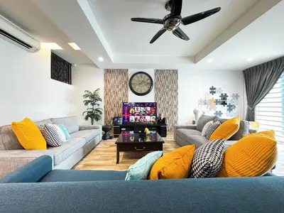 a living room with couches and a ceiling fan at i Homes Villa 2 at Ipoh Town 16 Guest in Ipoh