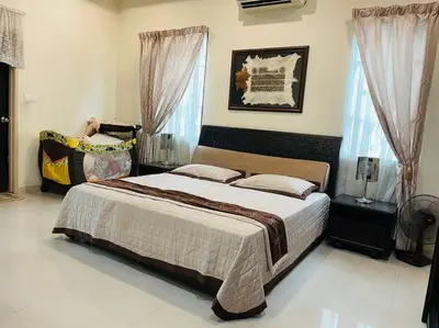 a bedroom with a large bed in a room at Bungalow in exclusive area in Nibung Tebal