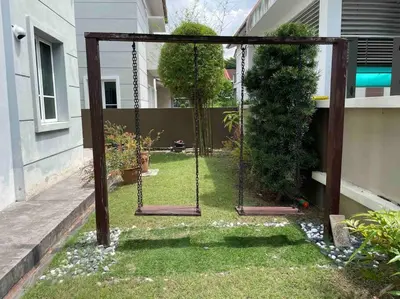 a swing in the yard of a house at Bungalow in exclusive area in Nibung Tebal