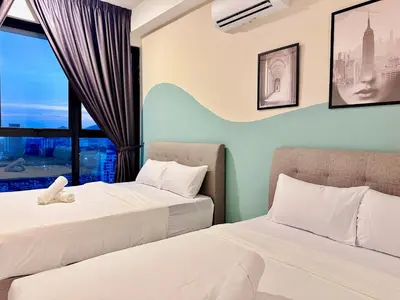 two beds in a room with a window at 2 bed room 5 queen bed luxury sea view apartment in Jelutong