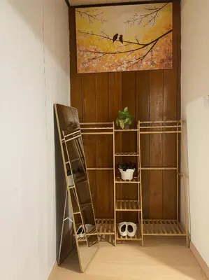 a room with shelves and a painting on the wall at Manson Goat Cottage in Cameron Highlands