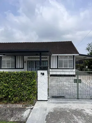 a white house with a fence and a garage at Canning 48 in Ipoh